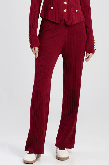 burgundy ribbed knit wide leg pants on a model with white sneakers