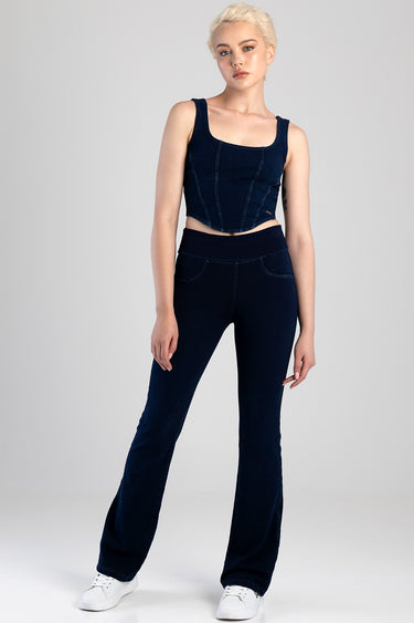 model wearing navy blue cropped denim top with wide straps and matching flare jeans, white sneakers