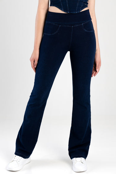 model wearing dark blue flare jeans with a high rise waistband and front pockets, paired with white sneakers