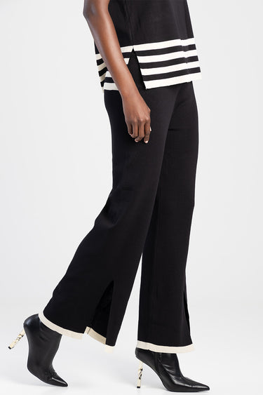 black knit wide leg pants with cream cuffs and ankle slits, paired with black heeled boots