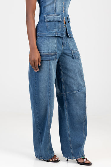 woman wearing blue denim cargo wide leg jeans with multiple pockets and exposed zipper