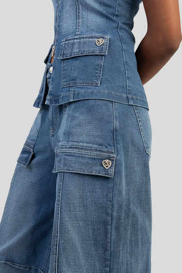side view of blue denim jeans with cargo pockets and a small heart emblem on the pocket flap