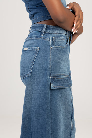 side view of a person wearing blue denim jeans with a cargo pocket and back pocket visible
