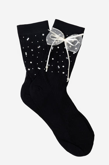 black knit socks with scattered rhinestones and pearls, a sheer white bow at the cuff