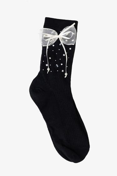 black ankle sock with a white sheer bow at the cuff and scattered pearls and beads
