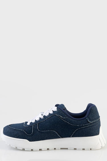 navy denim sneakers with white laces and a thick white sole, side view