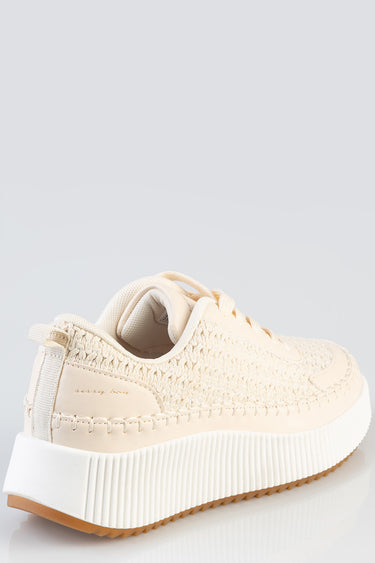 cream knitted sneaker with a thick white platform sole, tan gum bottom, back pull tab, and stitched detailing
