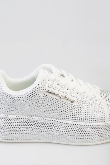 white sneaker encrusted with rhinestones and a metallic script logo on the side by Blue Jean Traders