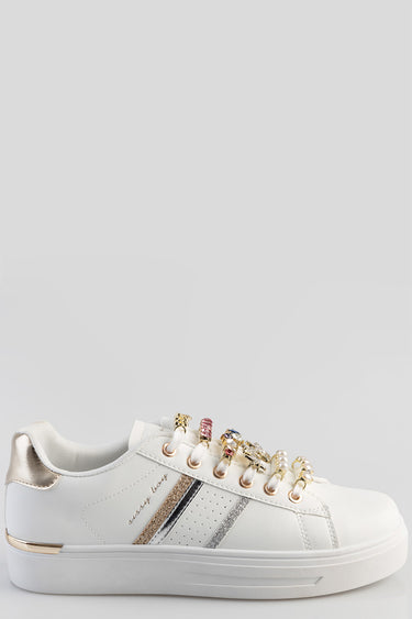 white sneakers with a gold metallic heel tab, gold and silver glitter stripes, and beaded lace decorations on a thick white
