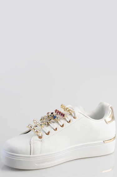 white leather sneaker with gold metallic heel and decorative crystal lace charms