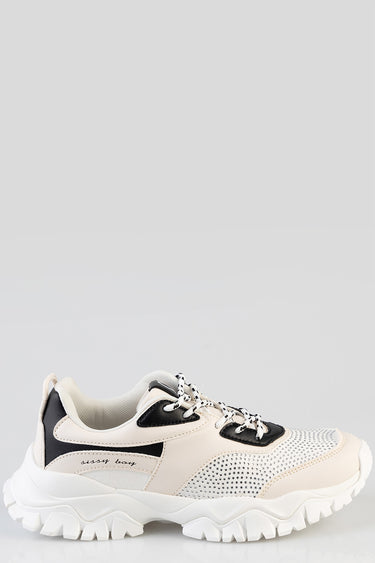 beige and white sneakers with black overlays, lace up, and chunky rubber sole