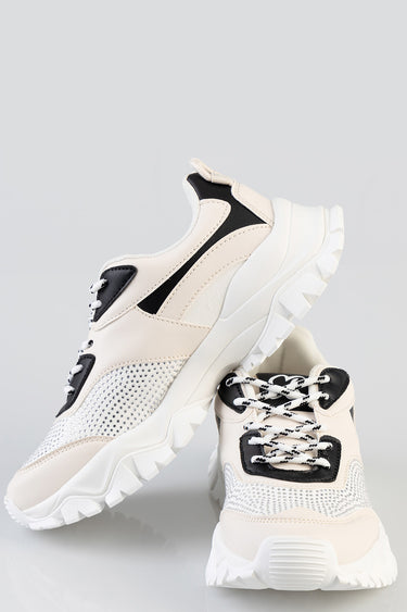 blue jean traders sneakers in beige and white with black detailing and a chunky sole