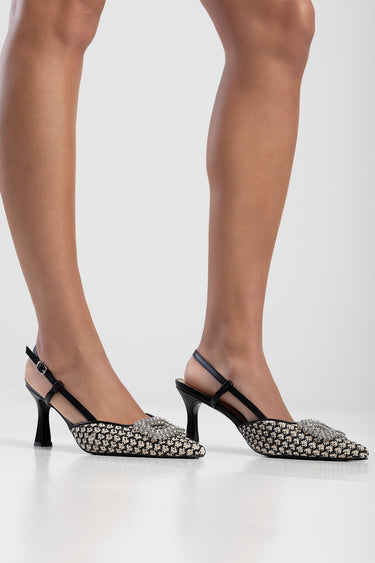 black slingback heels with a silver embellished pointed toe and ankle strap