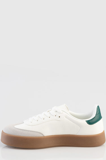 white sneaker with gum sole, white laces, and green heel counter