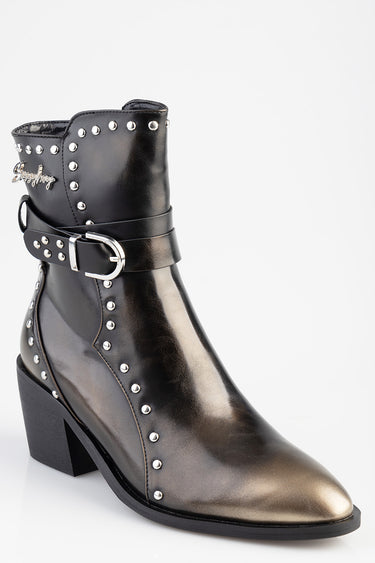 black patent ankle boot with silver studs along the shaft, a double strap with a metal buckle, and a chunky block heel
