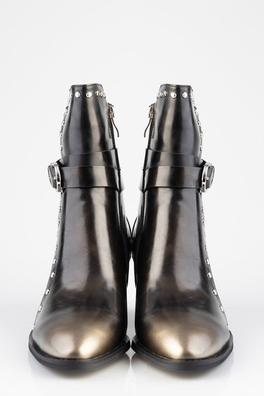 black leather ankle boots with a metallic finish, silver studs along the shaft and a wide buckle strap across the midfoot
