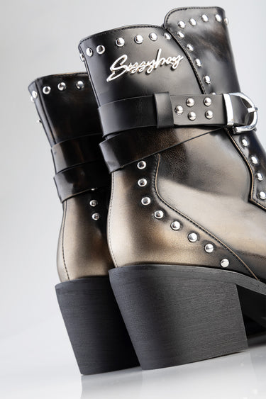 black leather ankle boots with silver studs, strap with buckle, and chunky heels.