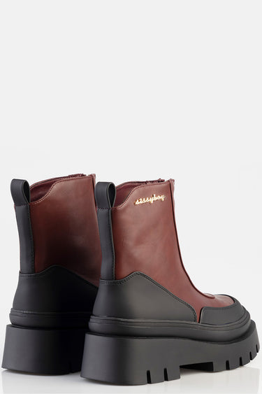 brown and black leather ankle boots with a chunky black sole and pull tabs, gold logo on the side