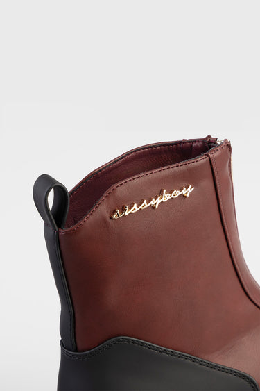 burgundy leather ankle boot with black sole and pull tab, gold script logo on side