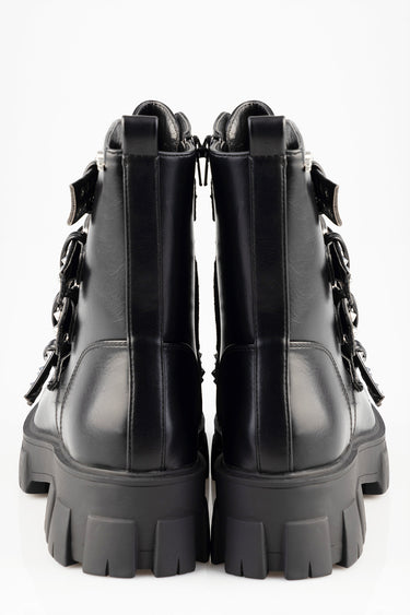 rear view of black leather boots with thick lug soles, zip closures and side buckle details