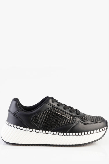 black sneaker with knit side panels and a thick white ridged sole