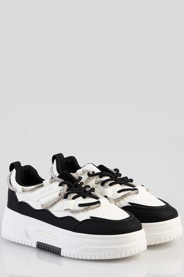 white and black chunky sneakers with silver laces and a thick sole, by Blue Jean Traders