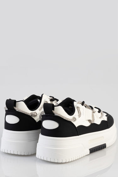 black and white chunky sneakers with a thick white sole and silver lace loops