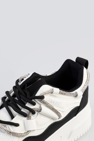 white and black sneakers with crystal rhinestone laces and a chunky sole