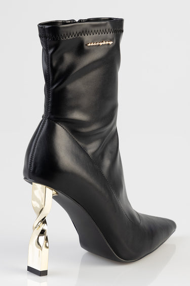 black leather ankle boot with a sculpted gold heel and visible top stitching
