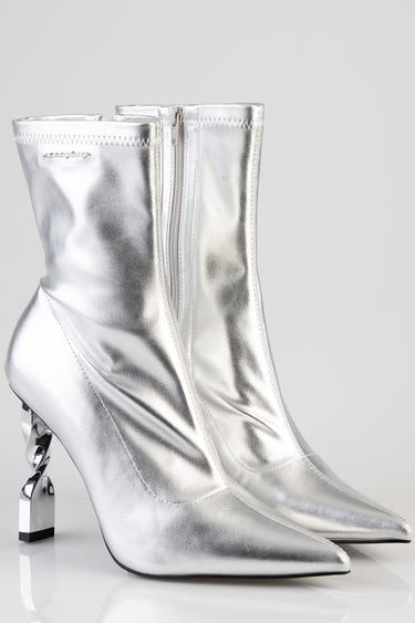 silver metallic mid calf boots with pointed toes and sculpted curved heels and a side zipper