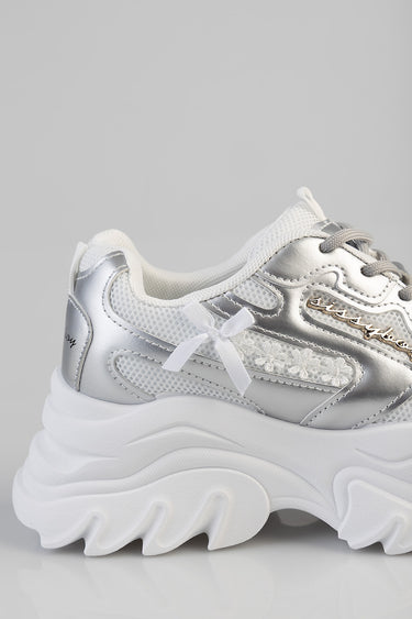 silver and white chunky sneaker with metallic overlays, mesh panels, lace up closure and a small white bow accent