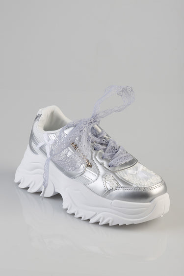 silver chunky sneaker with lavender lace tied in a bow and a thick white sole