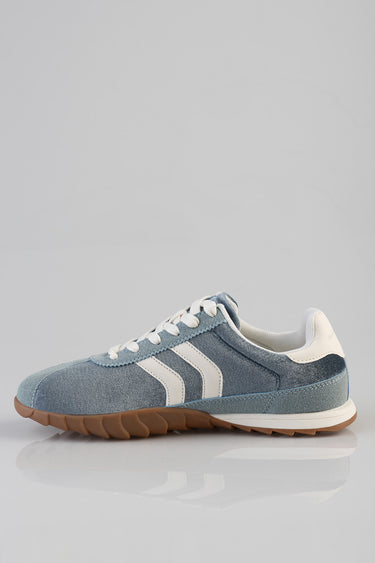 blue denim sneakers with white stripes, white laces, and a gum sole