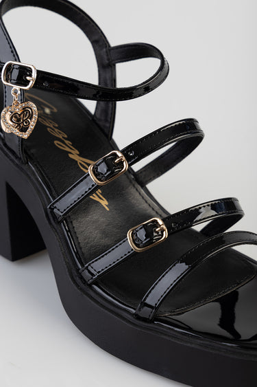 black patent strappy heel with gold buckles and heart charm