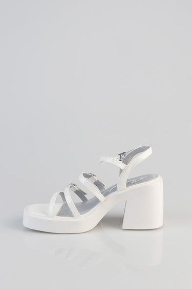 white chunky heel sandal with multiple straps and ankle strap on light grey background