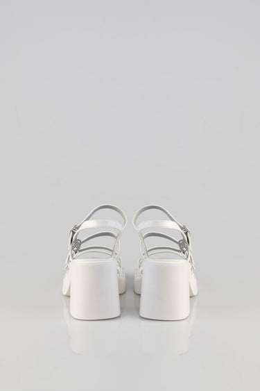 white heeled sandals with multiple slim straps and a chunky block heel, viewed from the back