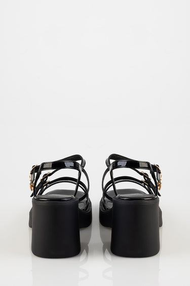 black strappy sandals with chunky block heels and gold buckles back view