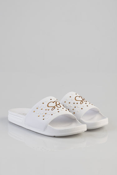 white slides with pearl and gold stud accents and bow detail