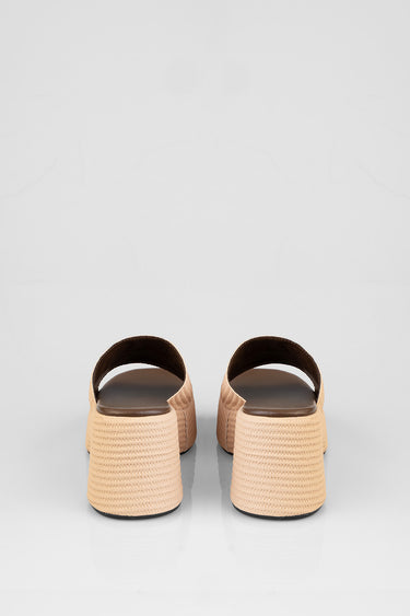 two beige platform sandals seen from behind with woven rope soles and brown footbeds
