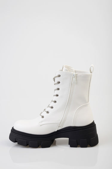 white ankle boot with thick black platform sole, lace-up front with metal eyelets and a side zipper