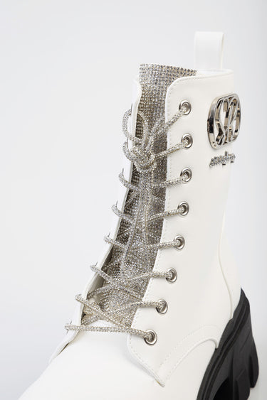 white ankle boot with a glittery silver panel, silver laces, metal eyelets and a chunky black sole