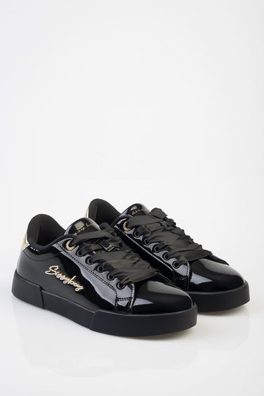 black patent sneakers by Blue Jean Traders with gold script logo on the side and a chunky black sole