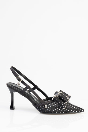 black slingback kitten heel with white polka dots, a sparkling rhinestone bow, and a thin ankle strap with buckle