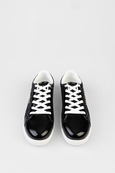 black patent leather sneakers with white laces, top view of a pair