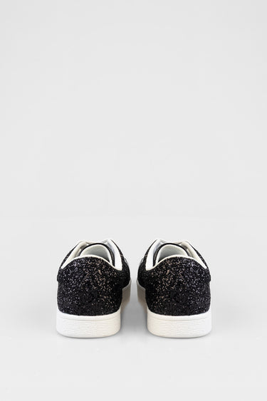 back view of glittery black sneakers with white rubber soles