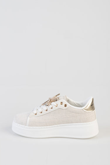 beige knit sneaker with a white platform sole, white laces, and a metallic gold heel accent