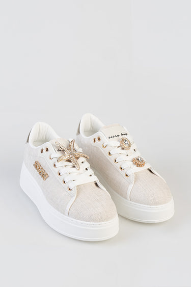 cream knit sneakers with white sole by Blue Jean Traders, starfish charm on one lace and jeweled circular charms on the other