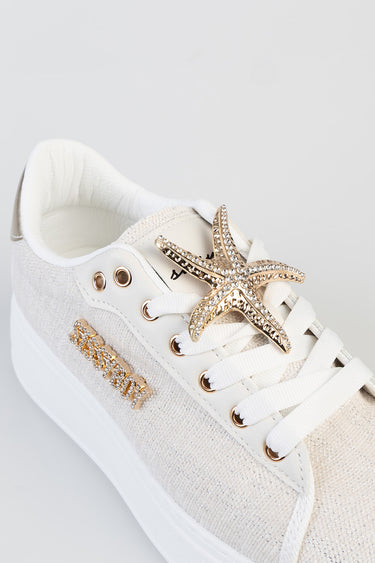 cream sneaker with white laces, starfish rhinestone charm on the laces and gold rhinestone lettering on the side