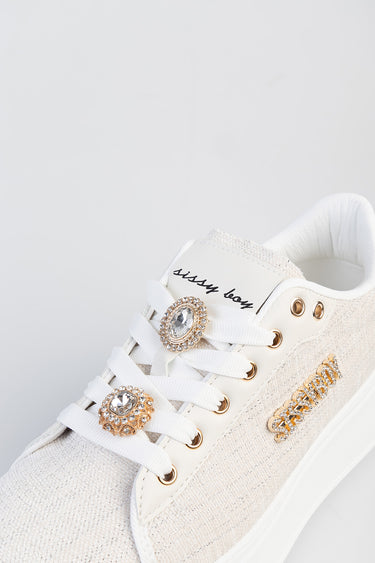 white sneakers with crystal jewel on the laces, gold eyelets and beige knit panels