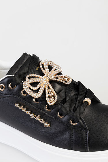 Blue Jean Traders black sneaker with white sole and rhinestone bow embellishment